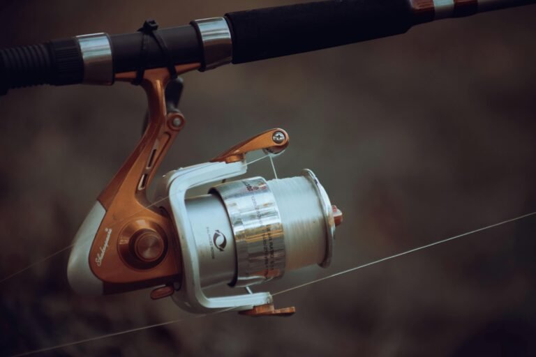 Detailed view of a fishing reel with line tension, showcasing precise fishing equipment mechanics.