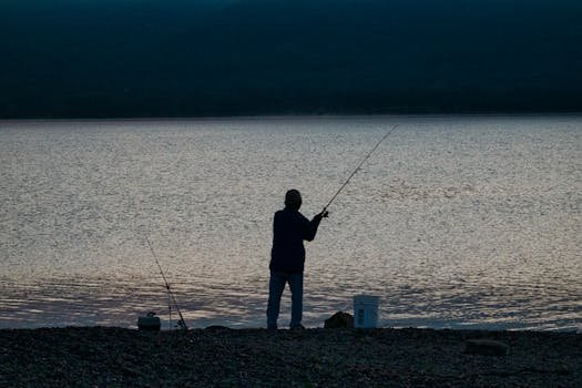 A man fishing for bass at night